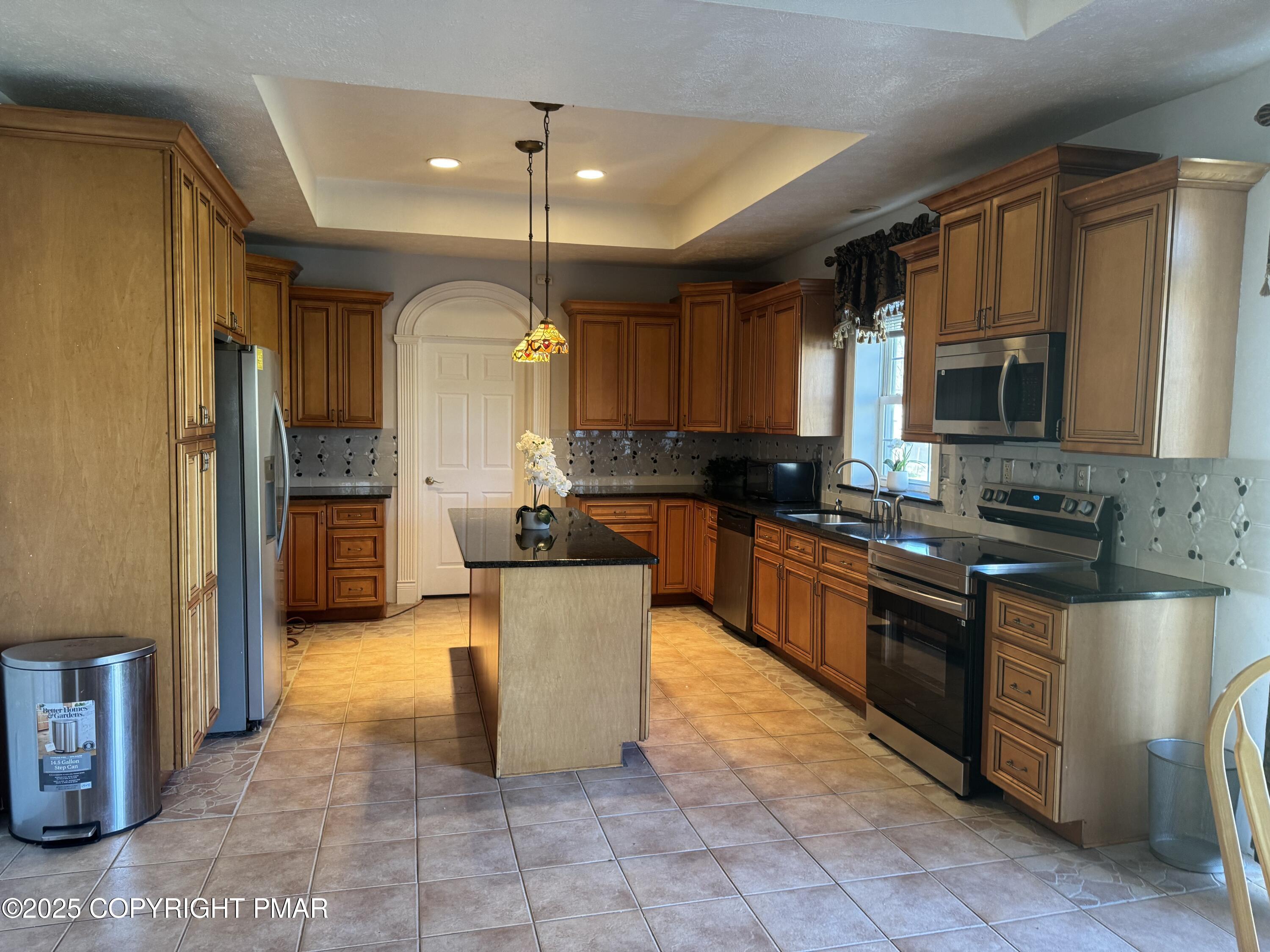 369 Bossardsville Road Stroudsburg, PA 18360 - Photo 3 of 17 a large kitchen with granite countertop a large counter top space a sink stainless steel appliances and cabinets