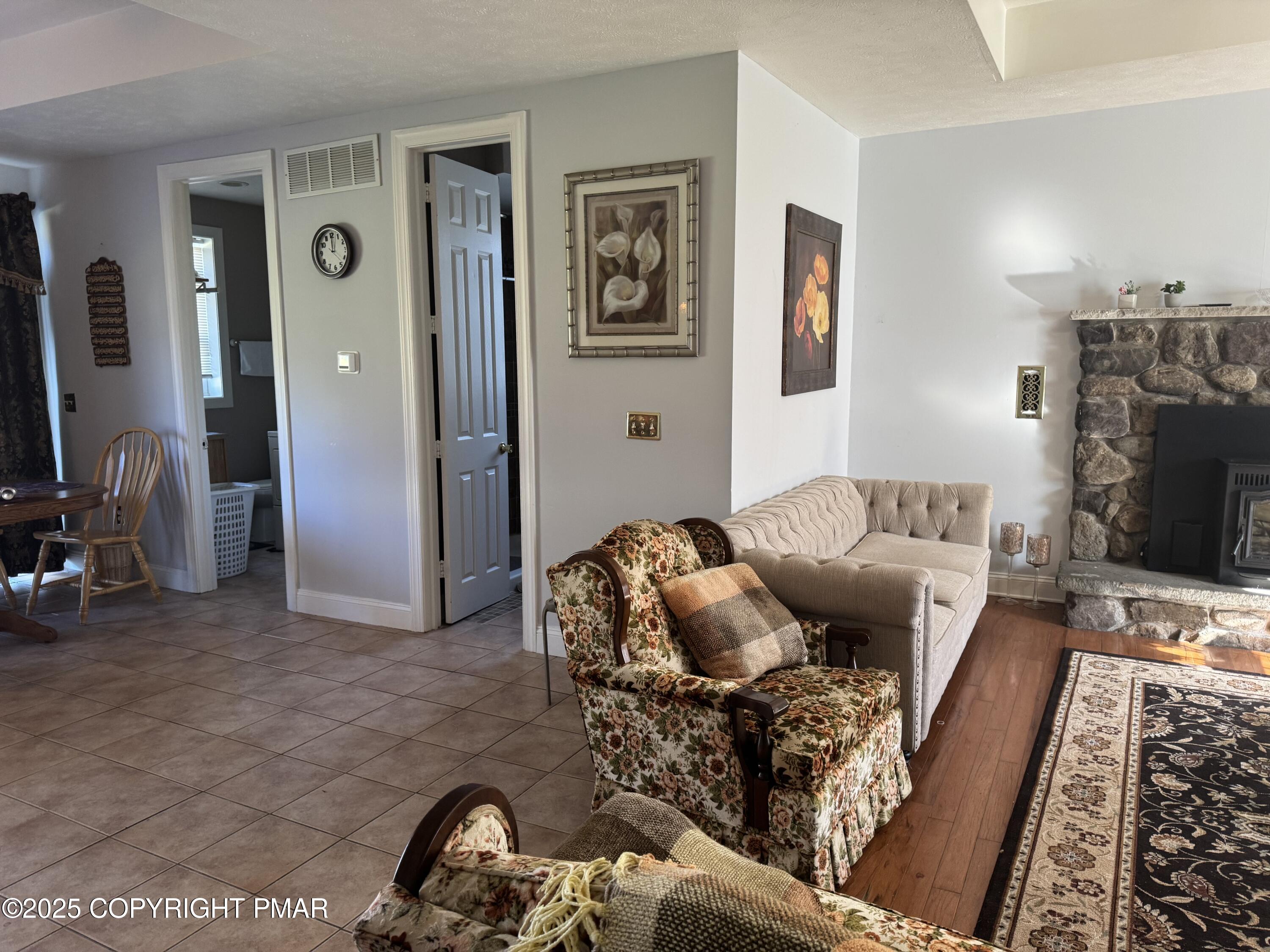 369 Bossardsville Road Stroudsburg, PA 18360 - Photo 6 of 17 a living room with furniture and a flat screen tv