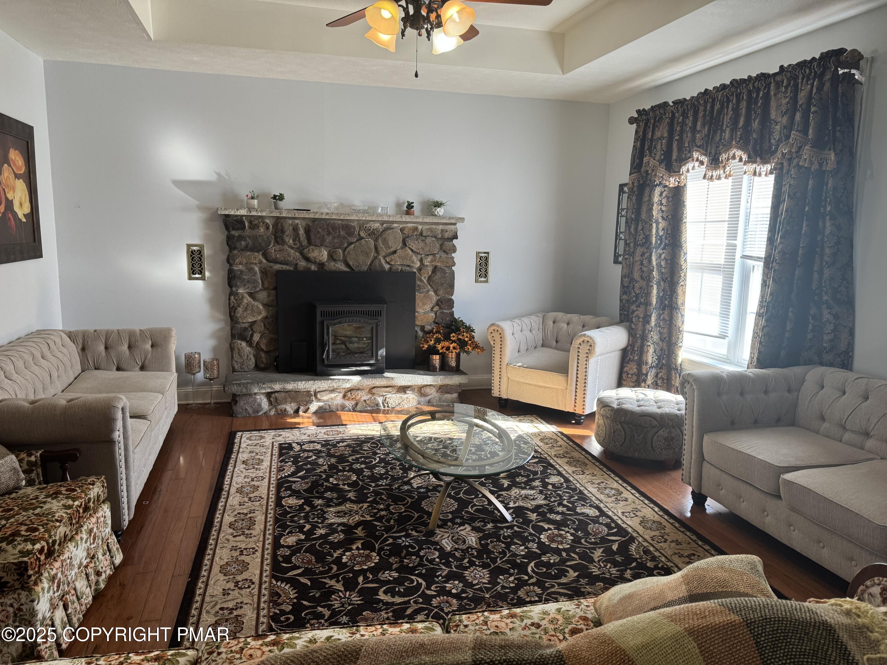 369 Bossardsville Road Stroudsburg, PA 18360 - Photo 8 of 17 a living room with furniture and a fireplace
