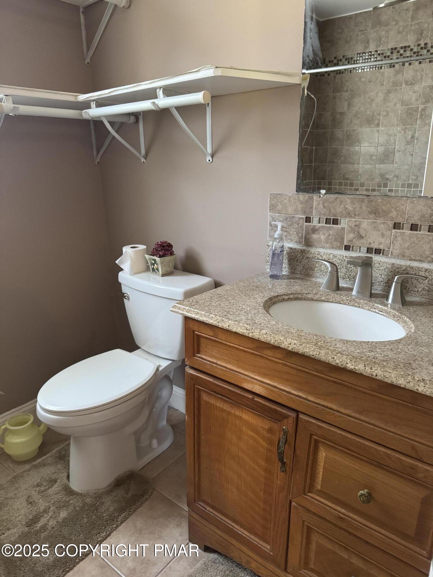 369 Bossardsville Road Stroudsburg, PA 18360 - Photo 9 of 17 a bathroom with a granite countertop toilet sink and mirror