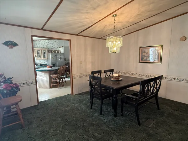 a view of a dining room with furniture and chandelier