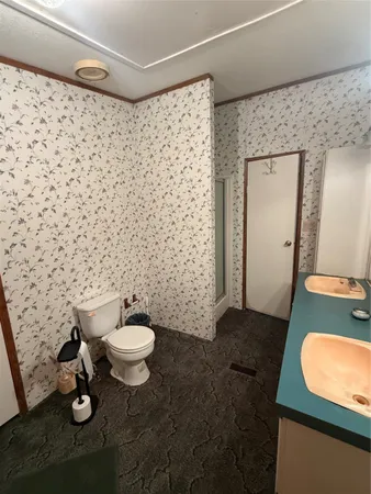 a bathroom with a sink toilet and mirror