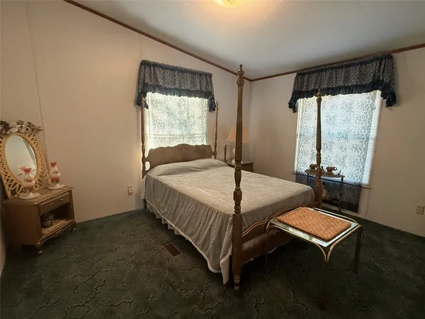a bed sitting in a room next to a window
