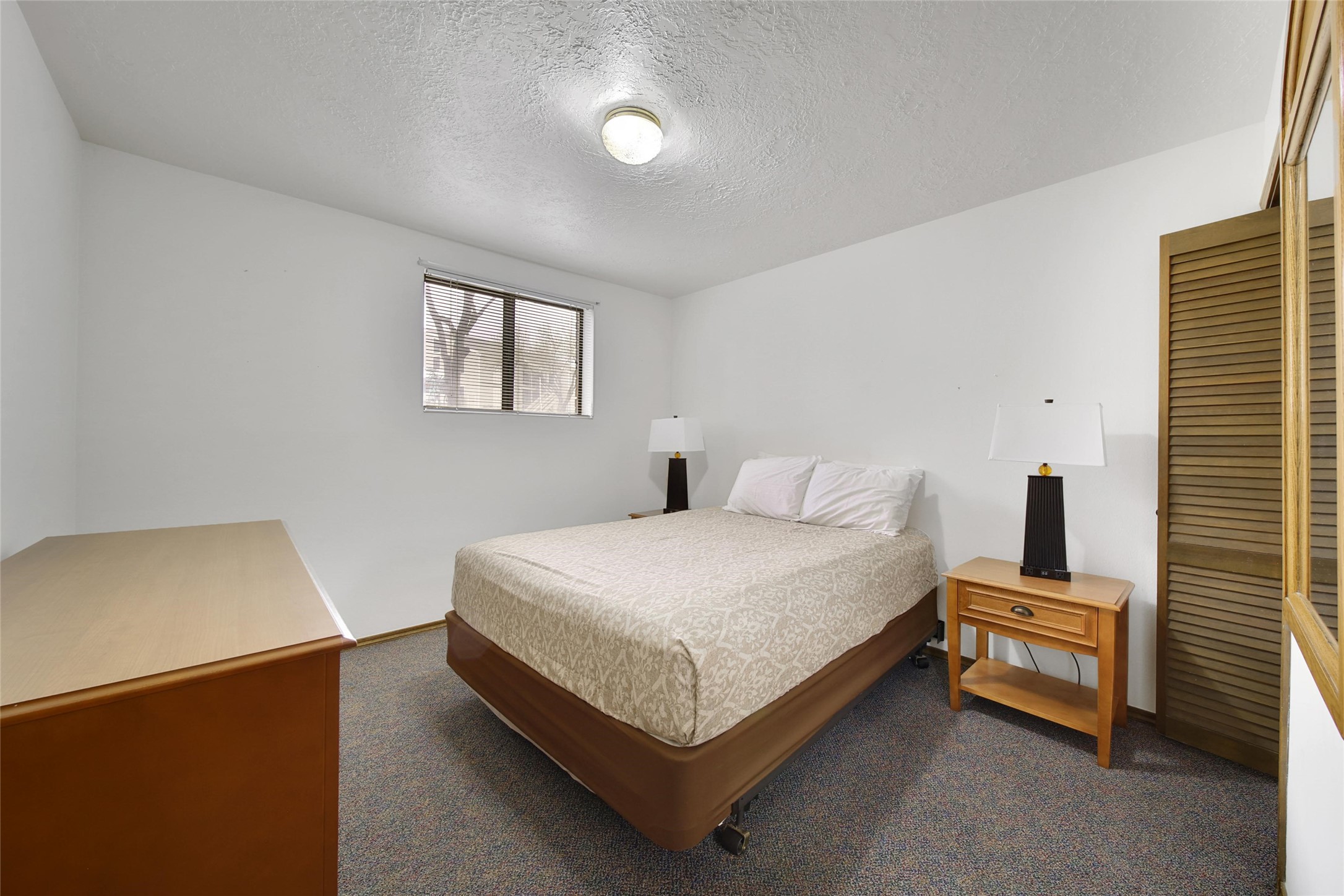 1000 April Sound Boulevard Conroe, TX 77356 - Photo 27 of 46 a bedroom with a bed and a night stand