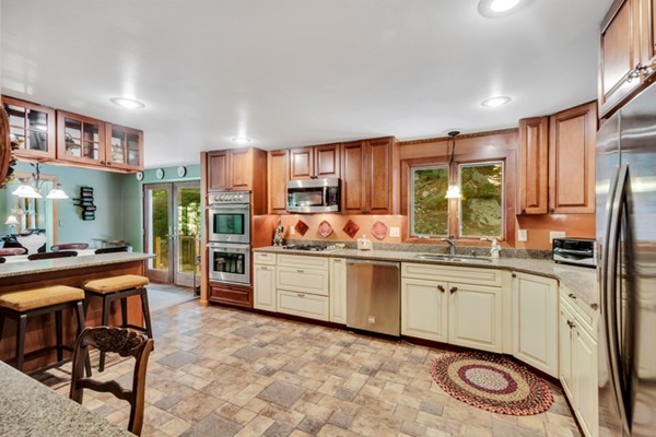 67 Chester Road Boxborough, MA 01719 - Photo 13 of 28 a kitchen with stainless steel appliances granite countertop a refrigerator and a stove top oven
