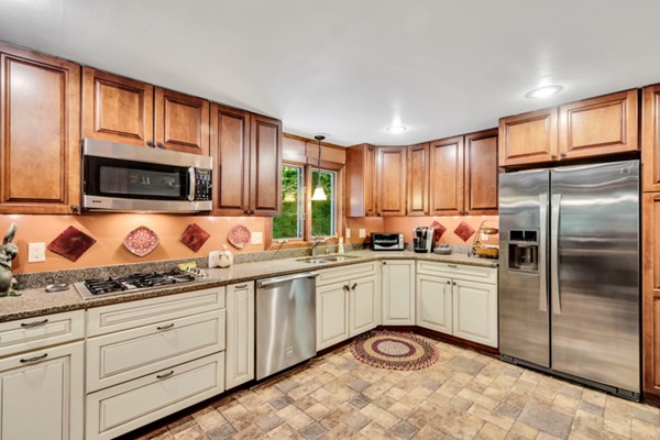 67 Chester Road Boxborough, MA 01719 - Photo 15 of 28 a kitchen with granite countertop stainless steel appliances a stove sink and microwave