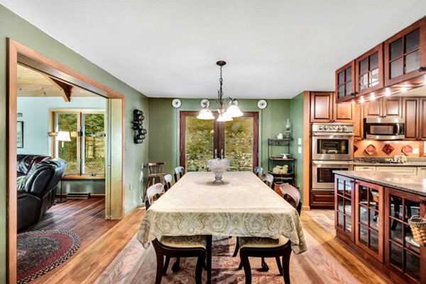 67 Chester Road Boxborough, MA 01719 - Photo 17 of 28 a dining room with furniture a chandelier and wooden floor