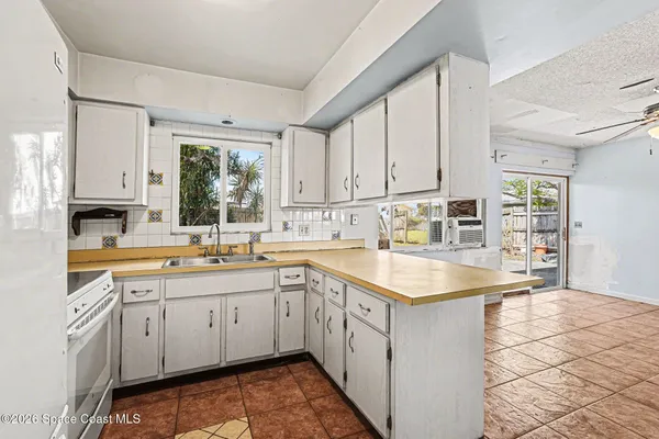 a kitchen with a sink stove and cabinets