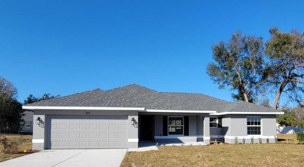 7613 Southwest 103rd Loop Ocala, FL 34476 - Photo 1 of 1 a front view of a house with a garden
