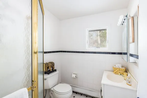 a white toilet sitting next to a bathroom sink