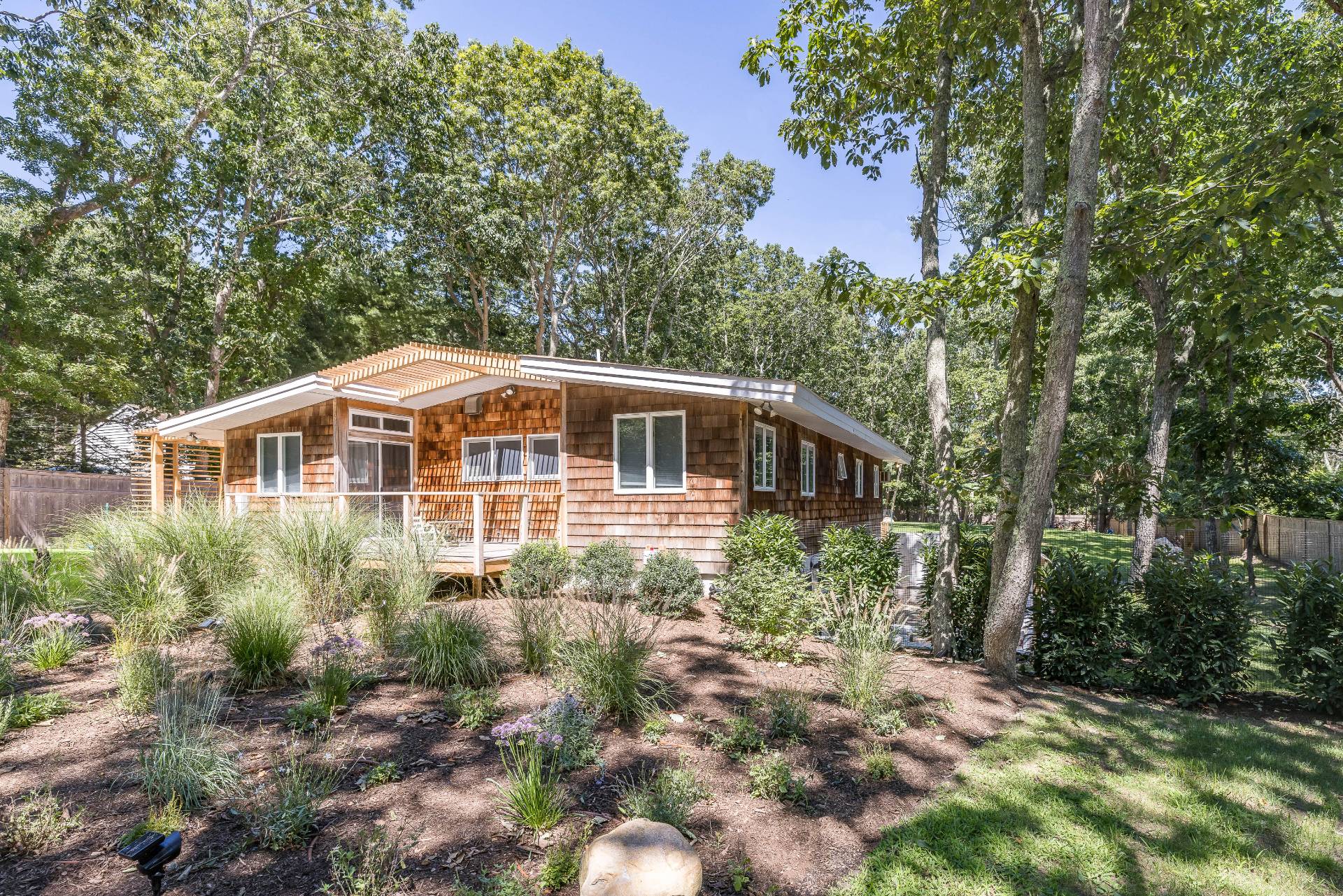 82 Springy Banks Road East Hampton, NY 11937 - Photo 20 of 21 a front view of a house with a garden
