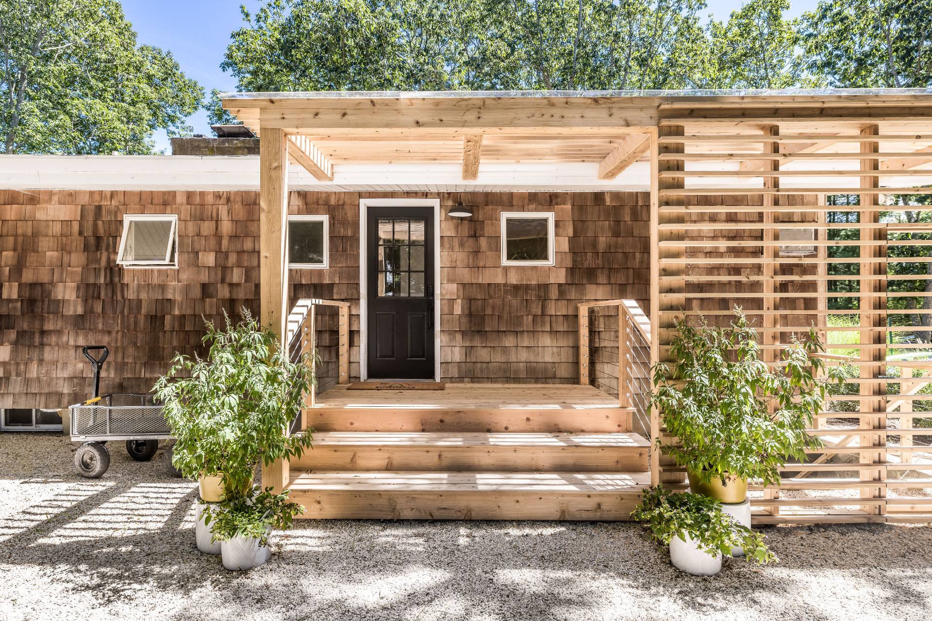 82 Springy Banks Road East Hampton, NY 11937 - Photo 2 of 21 a front view of a house with a garden