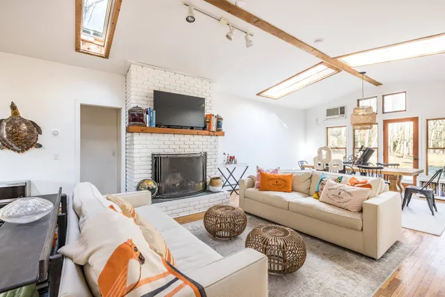 a living room with furniture fireplace and a flat screen tv