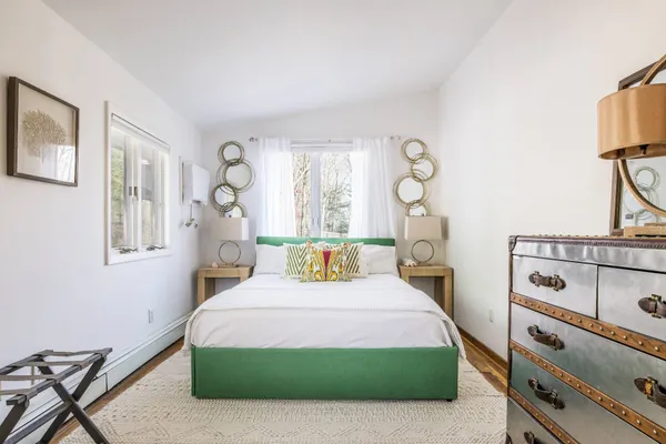 a bedroom with a bed and a window