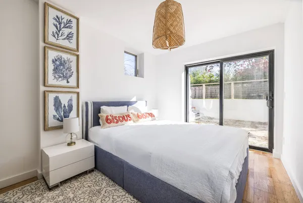 a bedroom with a bed and a large window