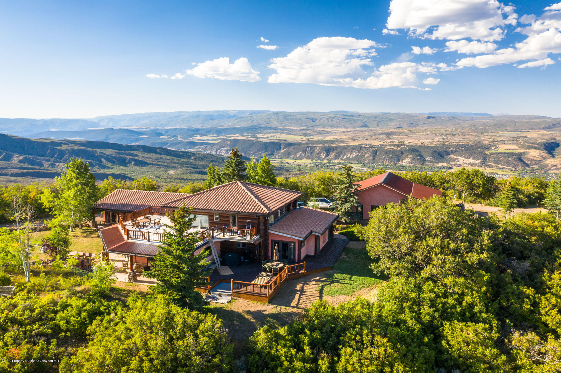 an aerial view of a house with swimming pool and ocean view