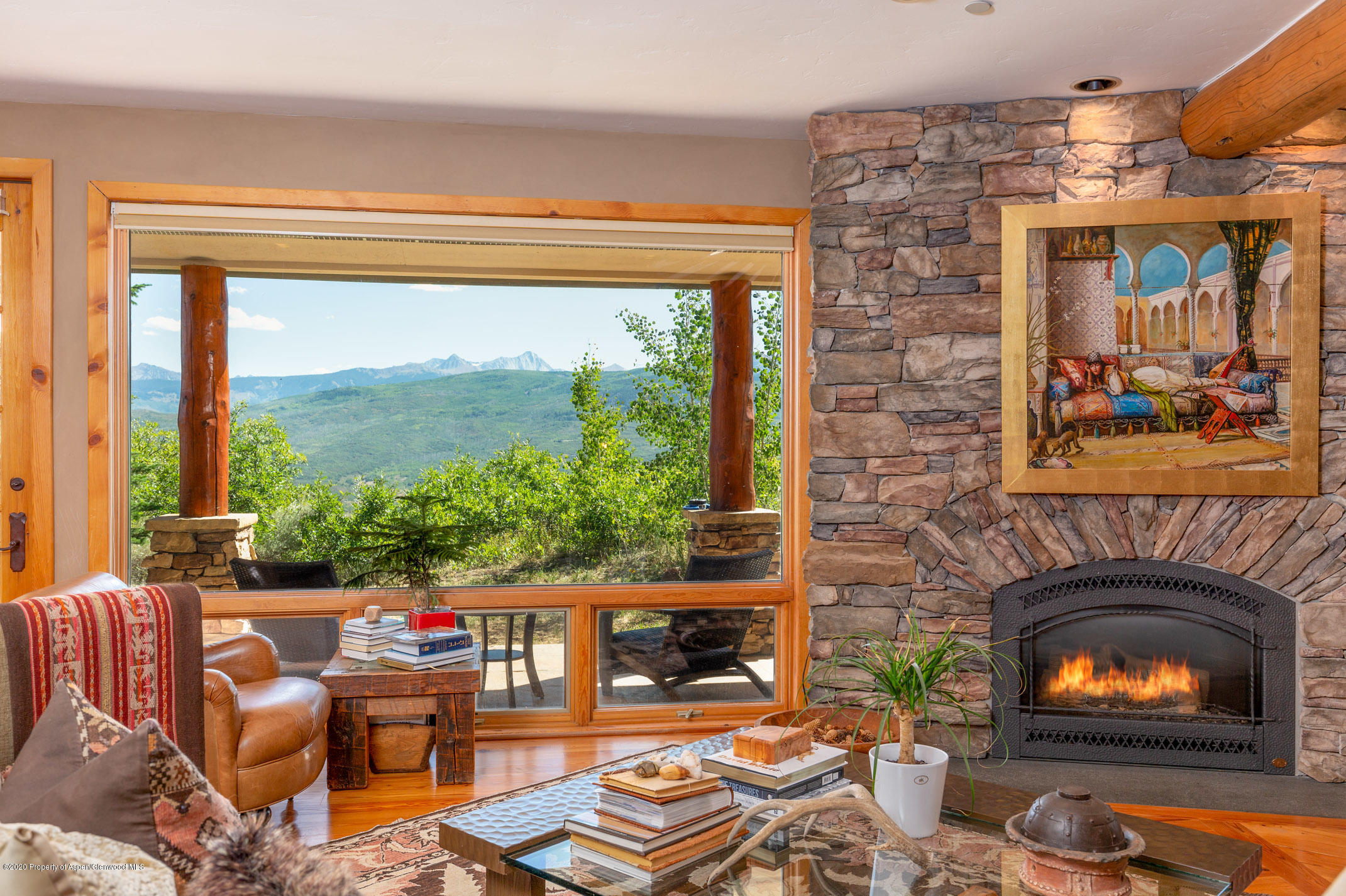 2000 Stone Road Basalt, CO 81621 - Photo 12 of 47 a living room with furniture a fireplace and a floor to ceiling window