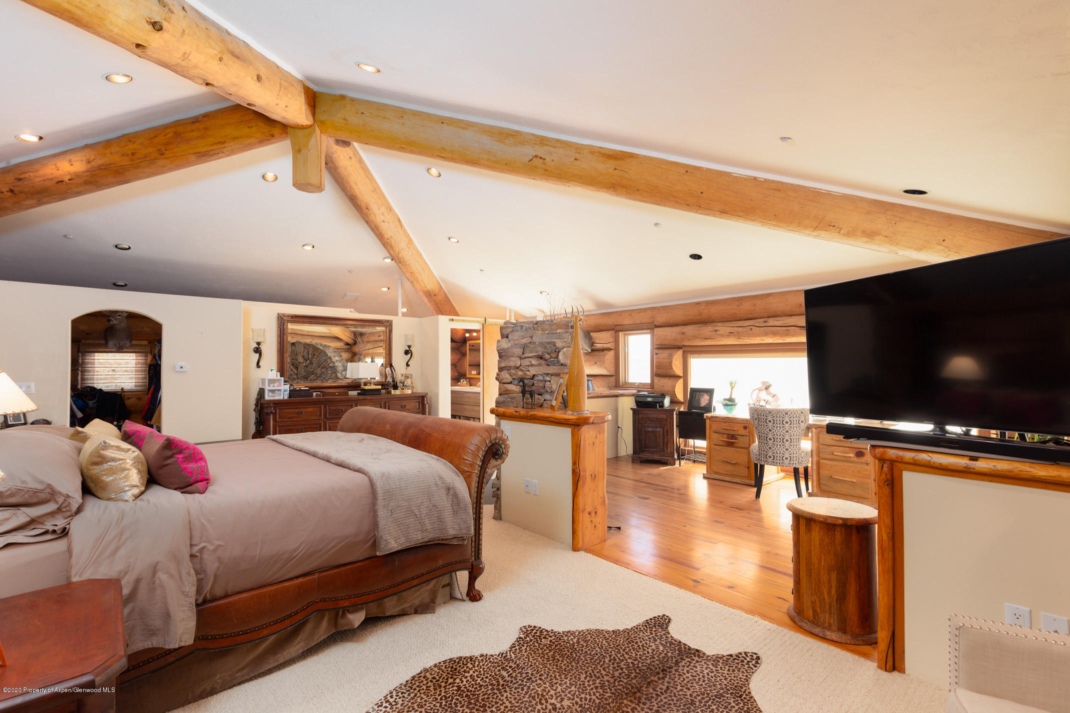2000 Stone Road Basalt, CO 81621 - Photo 19 of 47 a bedroom with a bed and large flat screen tv