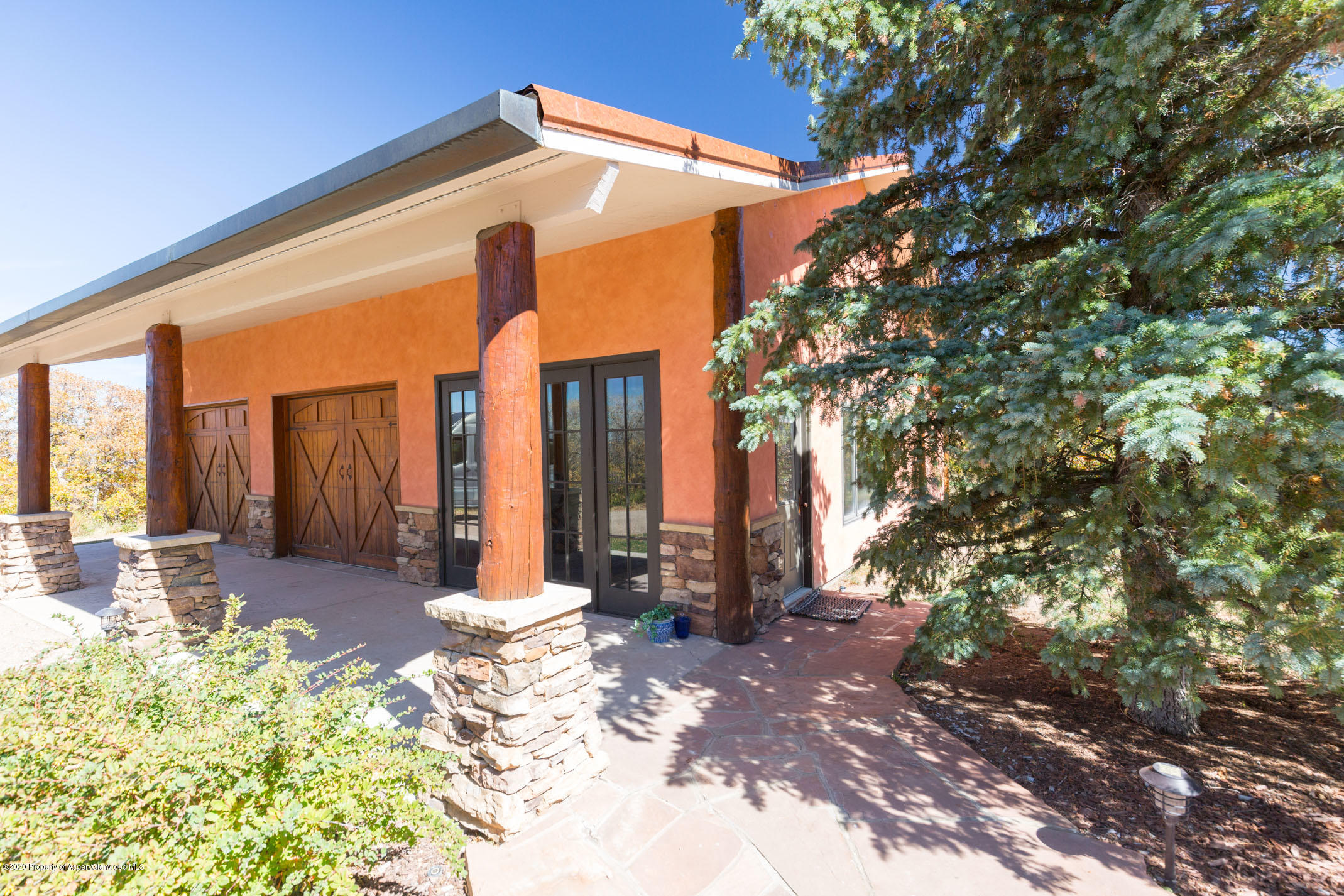 2000 Stone Road Basalt, CO 81621 - Photo 36 of 47 a front view of a house with large trees and plants