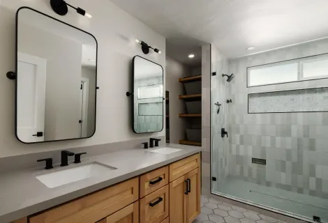 a bathroom with a sink a toilet and shower