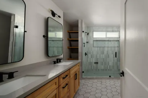 a bedroom with a large bed and a chandelier