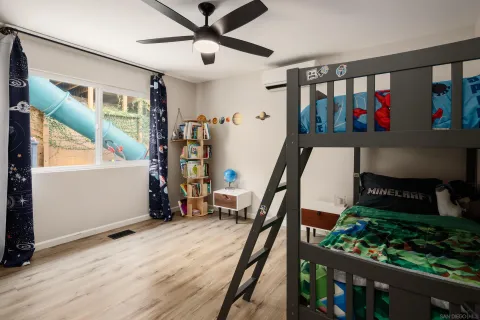 a view of a livingroom with furniture hardwood floor and hallway