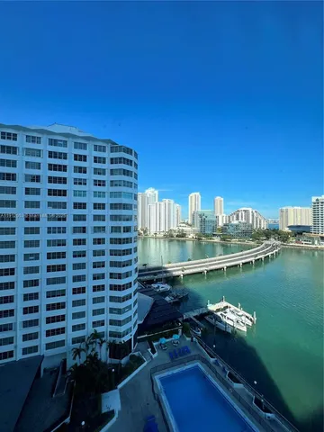 a view of a lake with tall buildings