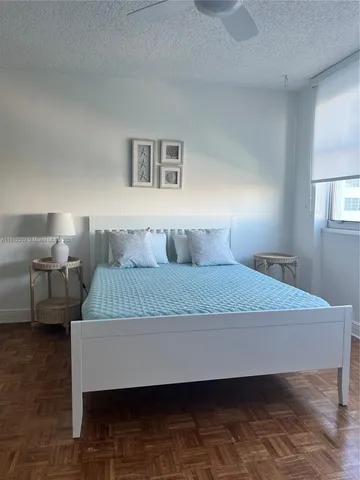 a bedroom with a bed and a night stand