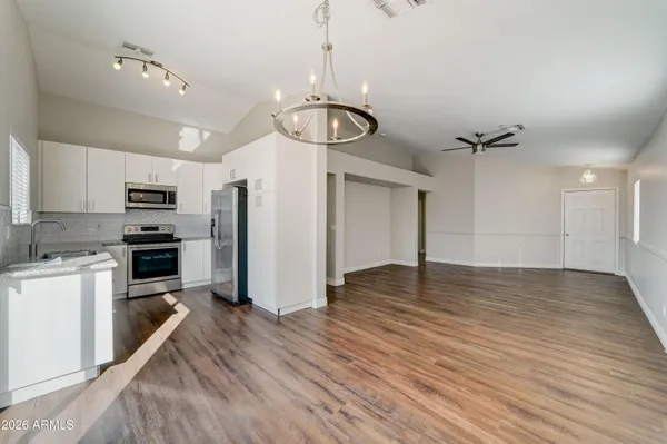a view of a kitchen with a sink and stainless steel appliances