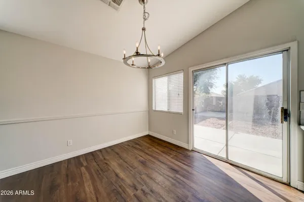 a view of a room with wooden floor and a window