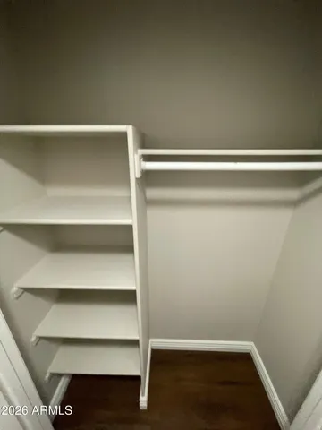 a view of walk in closet with empty racks