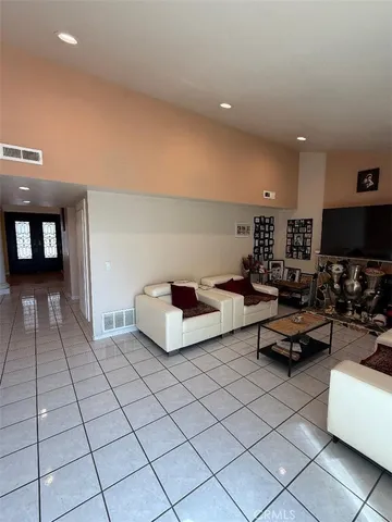 a living room with furniture and a floor to ceiling window