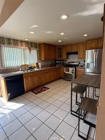 a kitchen with stainless steel appliances granite countertop a stove and a refrigerator