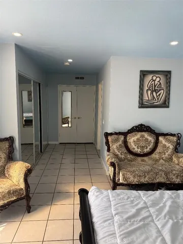 a bathroom with a granite countertop toilet sink and mirror