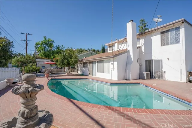 a view of a patio with table and chairs with wooden floor and fence