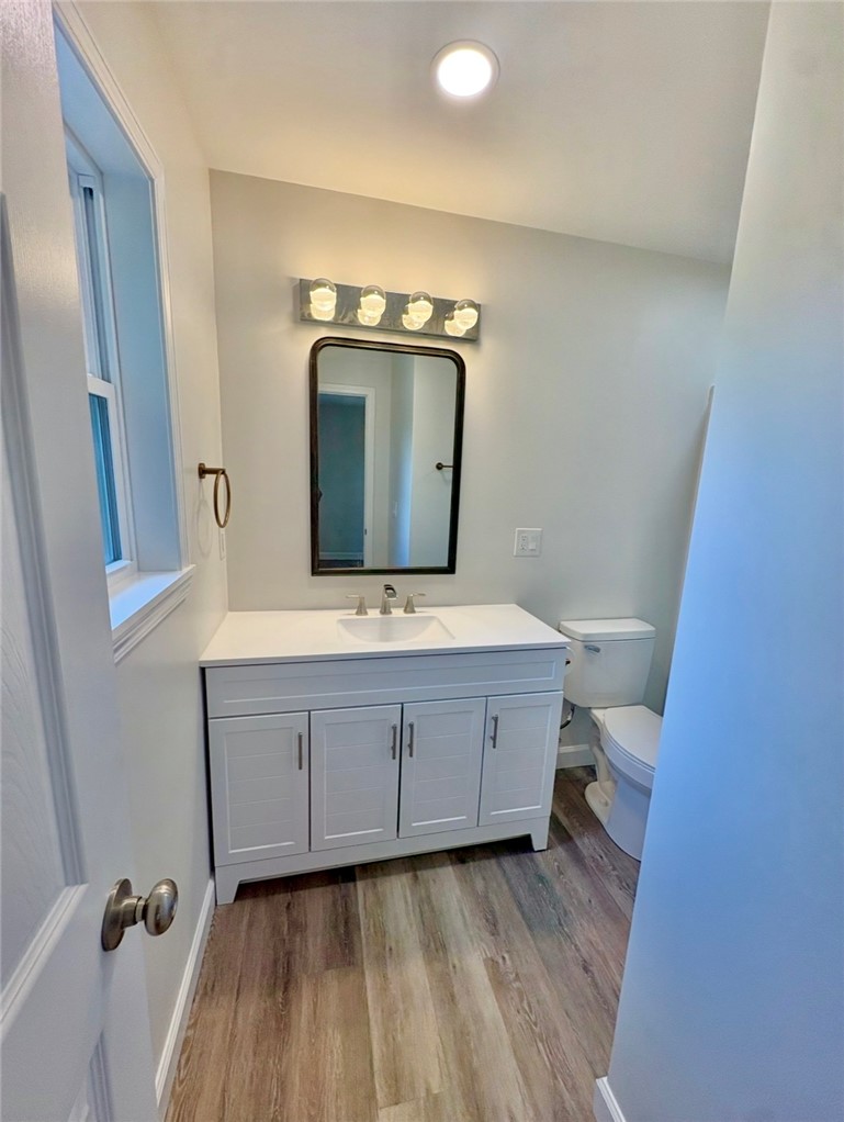 1904 East Calhoun Street Anderson, SC 29621 - Photo 17 of 36 A well-lit bathroom showcases a clean white vanity with a sleek sink and a modern framed mirror.