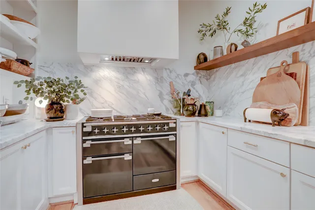 a stove top oven sitting inside of a kitchen