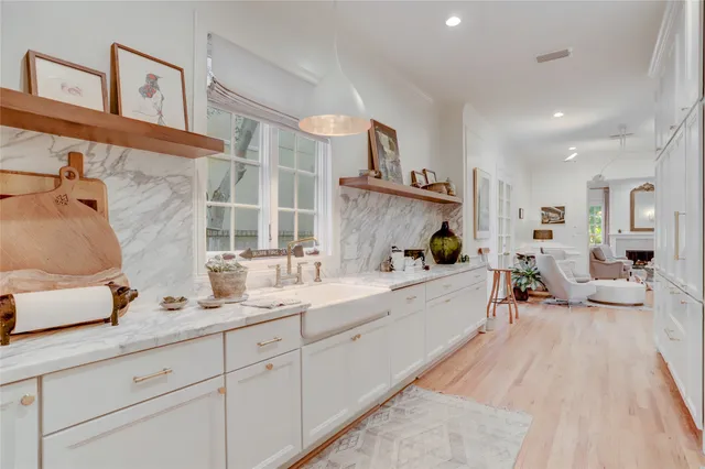 a bathroom with a toilet a sink a mirror and vanity