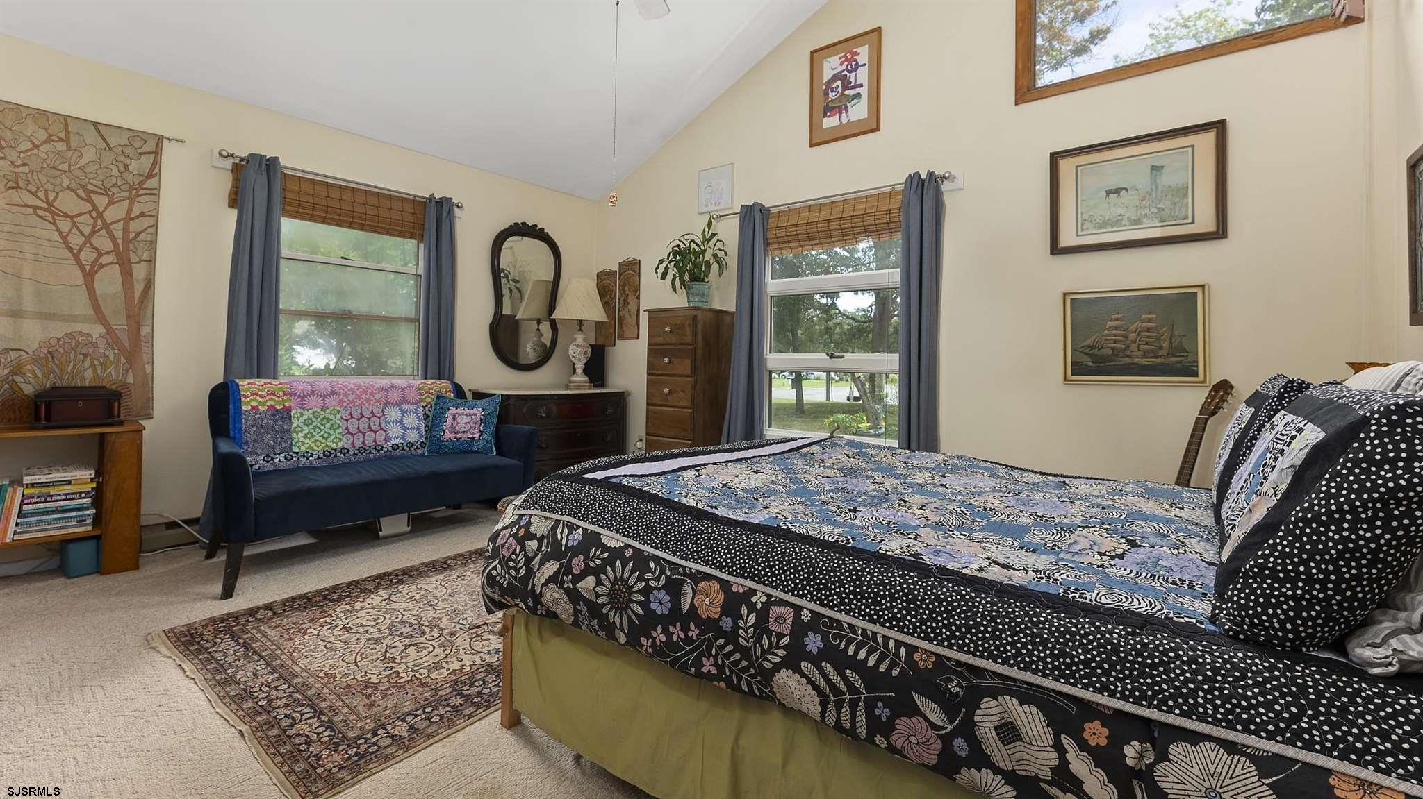 26 Indian Walk Road Ocean View, NJ 08230 - Photo 13 of 27 a bed sitting in a bedroom next to a window with outer view