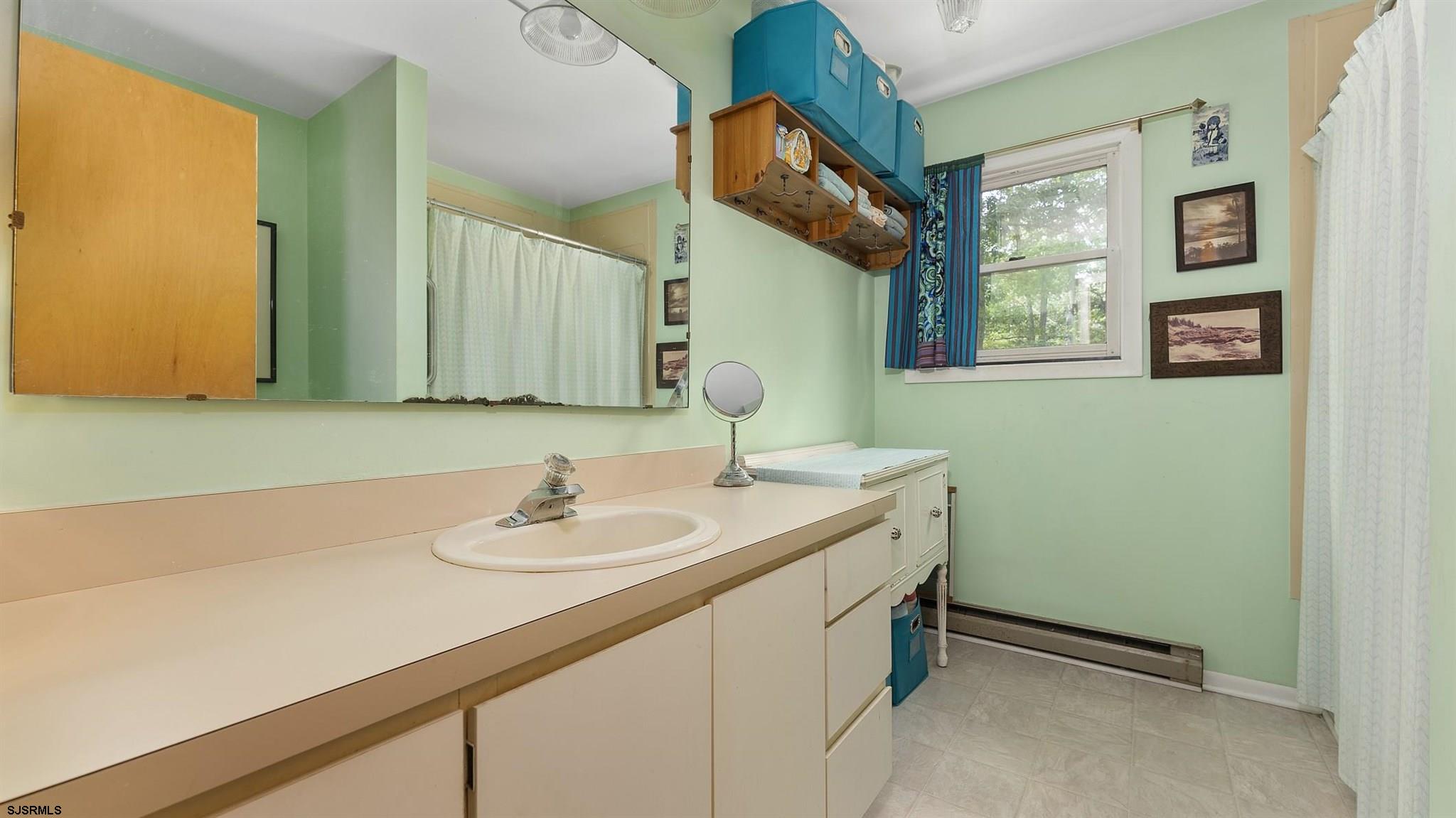26 Indian Walk Road Ocean View, NJ 08230 - Photo 16 of 27 a bathroom with a sink and a mirror