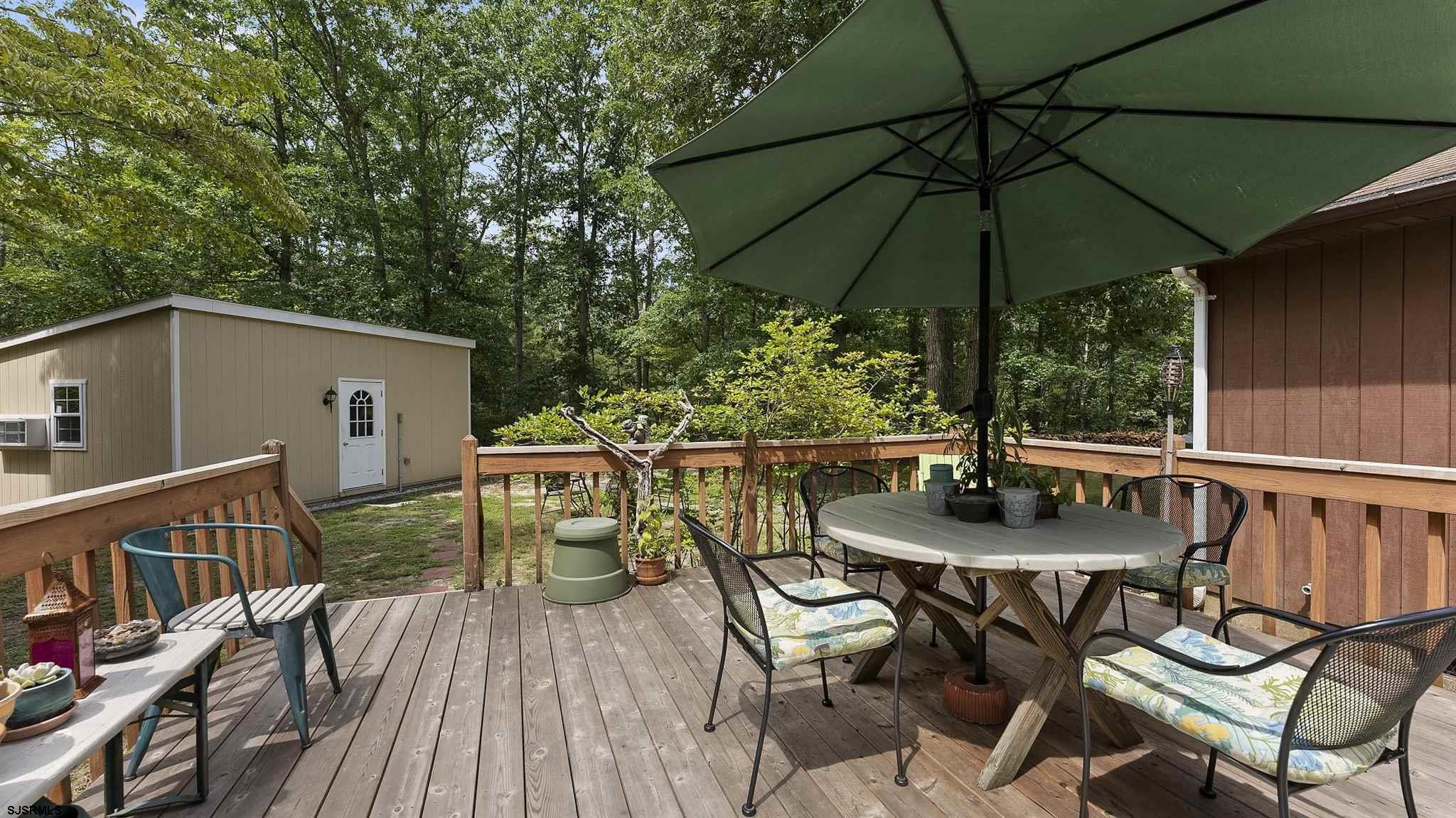 26 Indian Walk Road Ocean View, NJ 08230 - Photo 18 of 27 a view of balcony with table and chairs under an umbrella