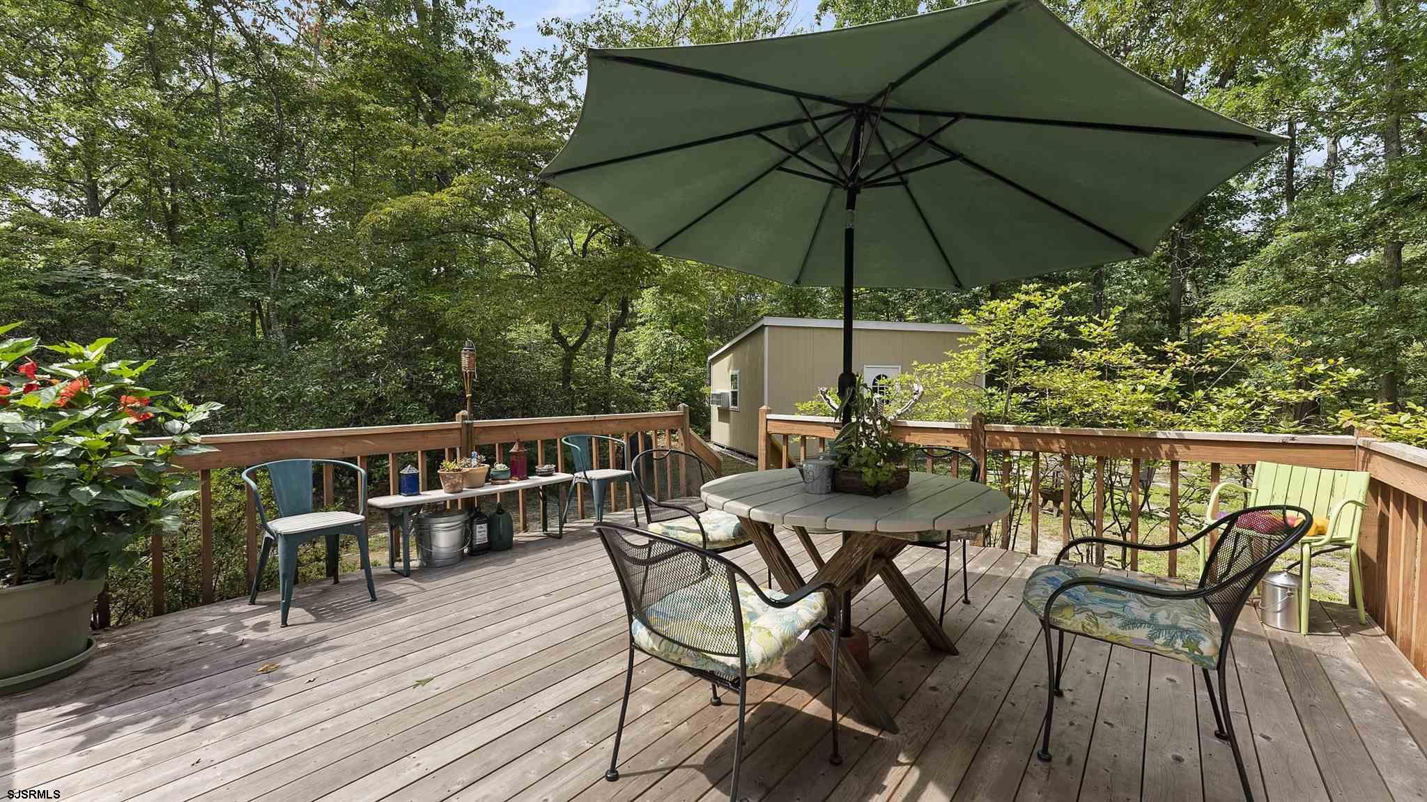 26 Indian Walk Road Ocean View, NJ 08230 - Photo 19 of 27 a view of table and chairs under an umbrella