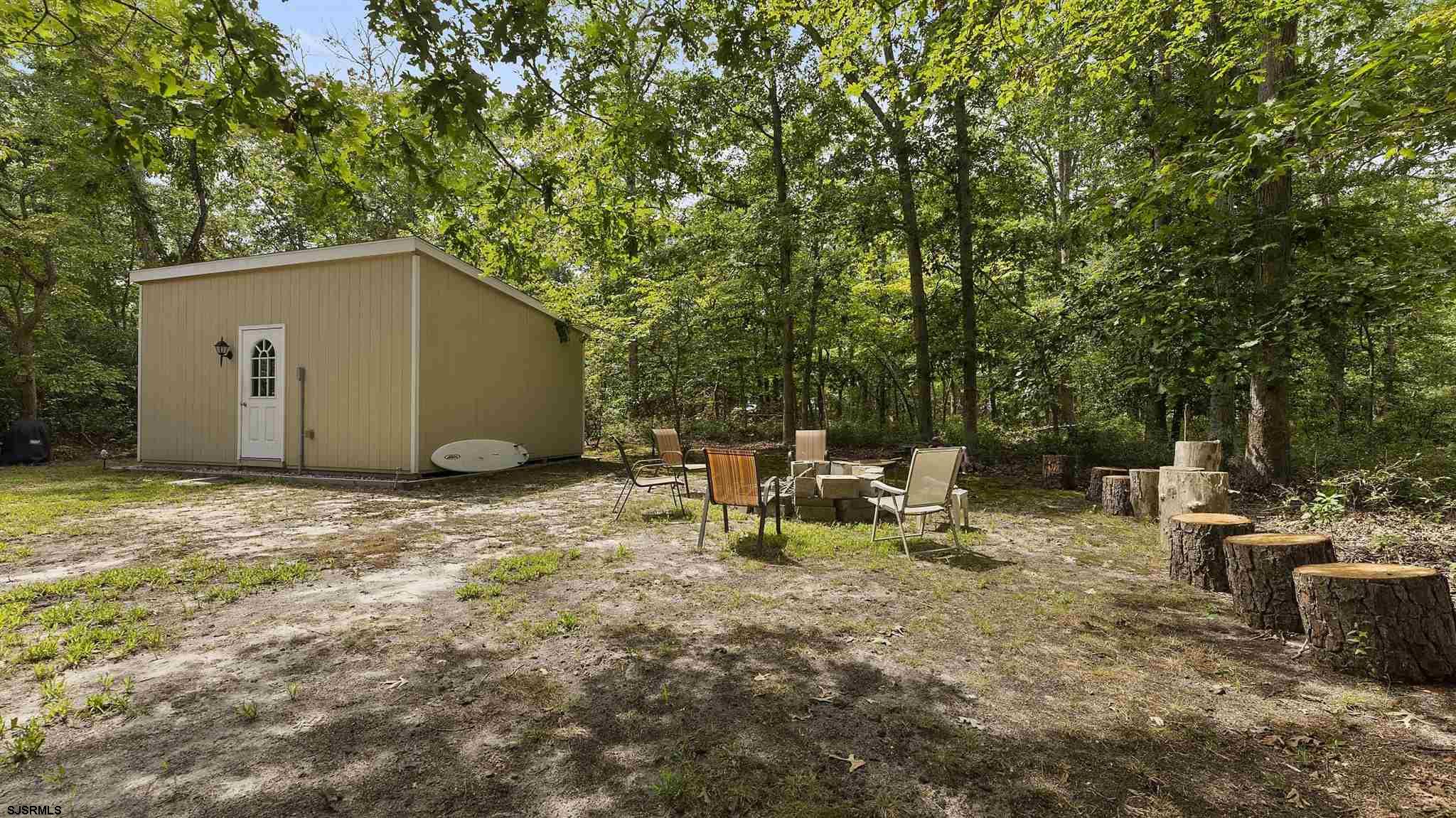 26 Indian Walk Road Ocean View, NJ 08230 - Photo 20 of 27 a view of backyard with table and chairs and wooden fence