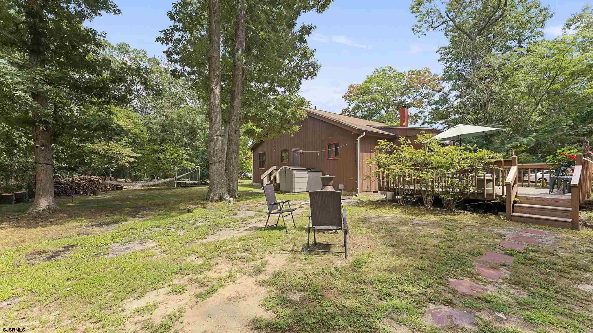 26 Indian Walk Road Ocean View, NJ 08230 - Photo 26 of 27 a backyard of a house with table and chairs