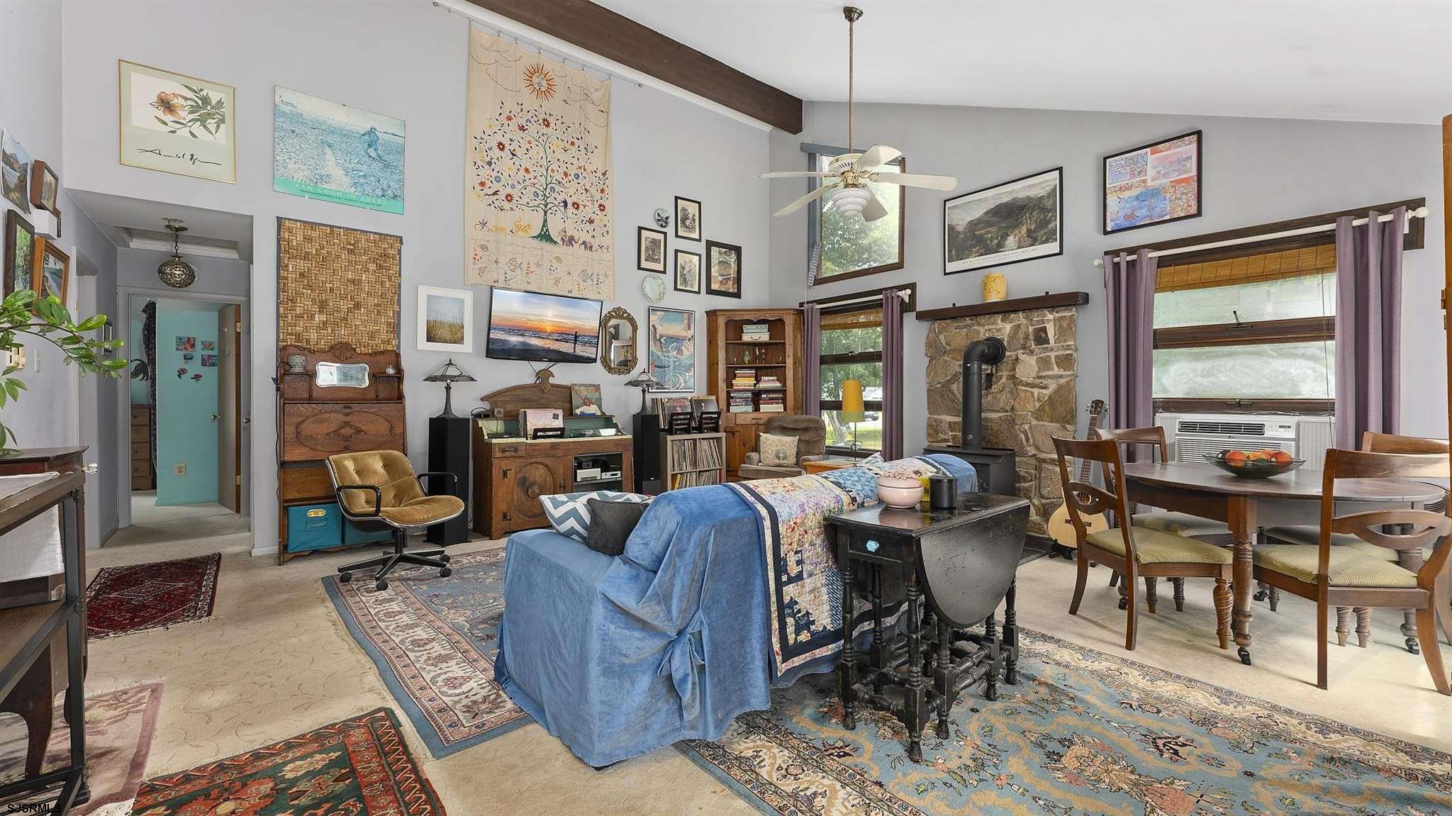 26 Indian Walk Road Ocean View, NJ 08230 - Photo 5 of 27 a living room with fireplace furniture and a large window