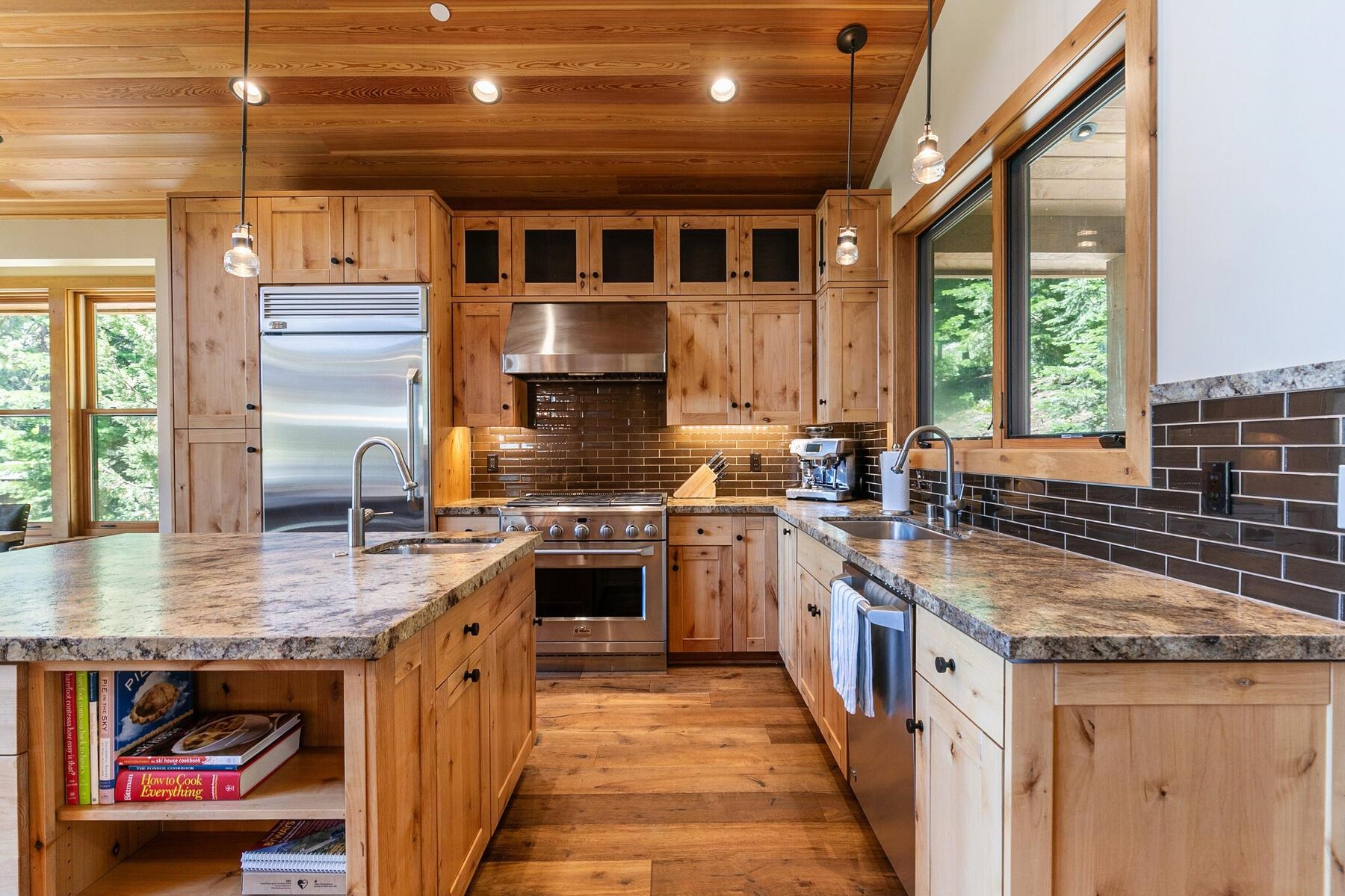 230 Shoshone Way Olympic Valley, CA 96146 - Photo 4 of 9 a kitchen with stainless steel appliances granite countertop a stove a sink and a microwave