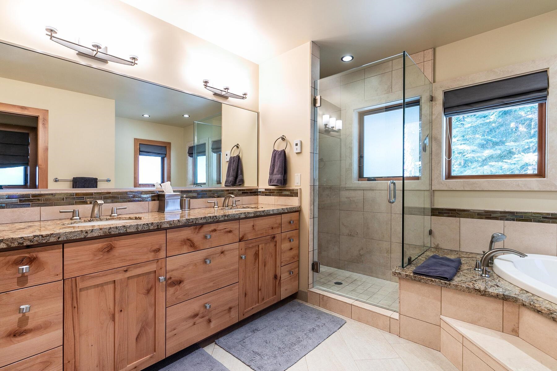 230 Shoshone Way Olympic Valley, CA 96146 - Photo 8 of 9 a spacious bathroom with a granite countertop sink a mirror a shower and a bathtub