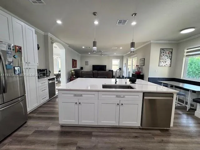 a kitchen with a sink stainless steel appliances and cabinets