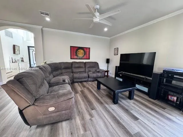 a living room with furniture and a flat screen tv