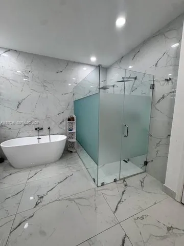a view of a bathroom with a sink and shower